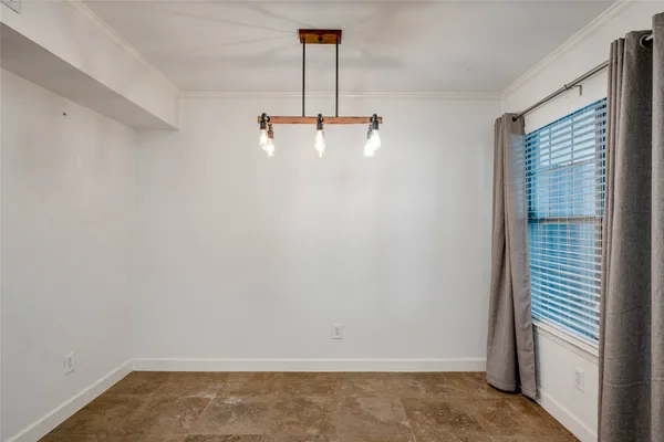 a view of a chandelier in big room and chandelier fan