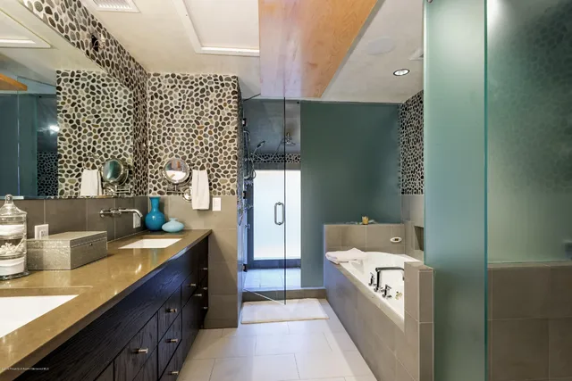 a bathroom with a sink double vanity and a shower