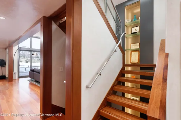 a view of entryway and hall with wooden floor