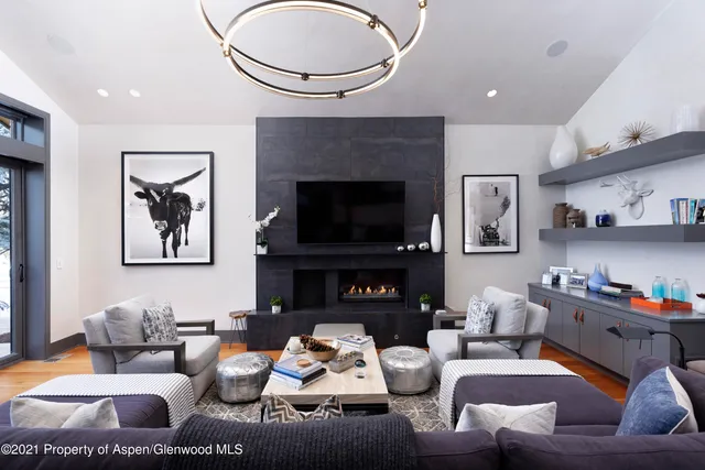 a living room with furniture a fireplace and a flat screen tv