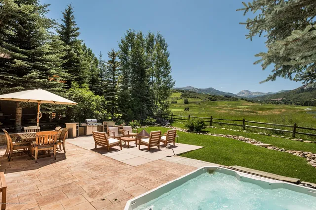 an outdoor space with patio and lake view