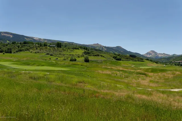 a view of a field with an ocean view