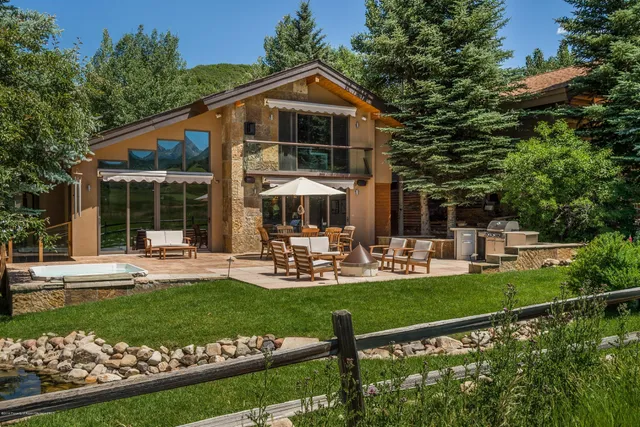 a front view of a house with swimming pool having outdoor seating