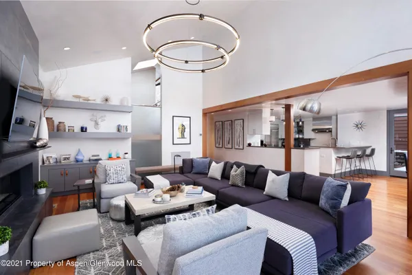 a living room with furniture a rug and a chandelier