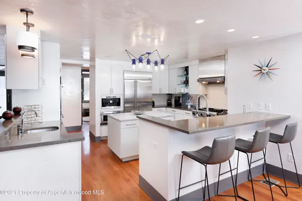 a kitchen with stainless steel appliances kitchen island granite countertop a sink and cabinets