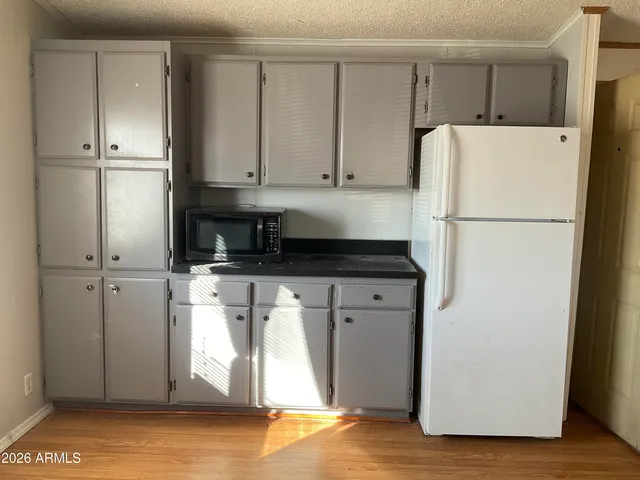 a white refrigerator freezer sitting in a kitchen