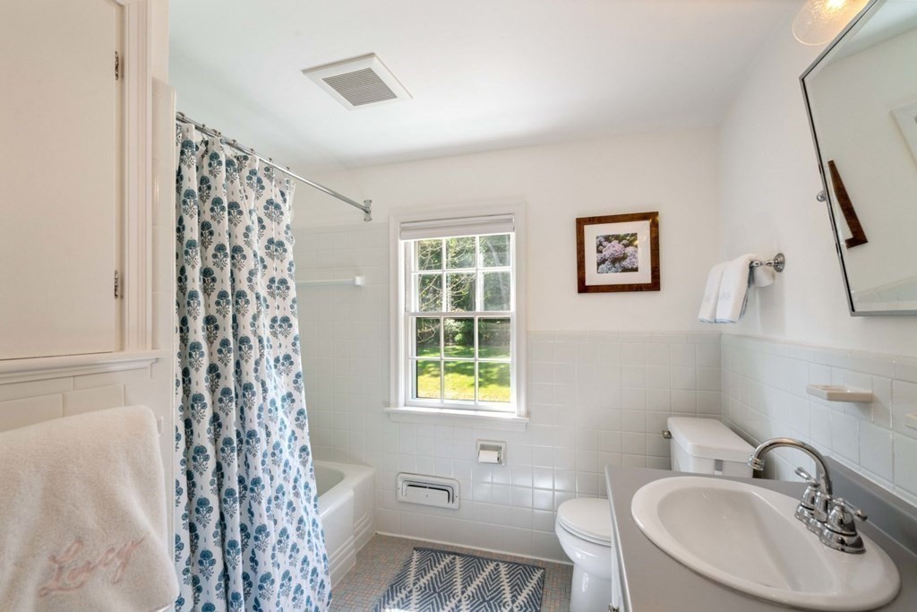 110 Suffolk Road Wellesley, MA 02481 - Photo 24 of 29 a bathroom with a sink a toilet and a mirror