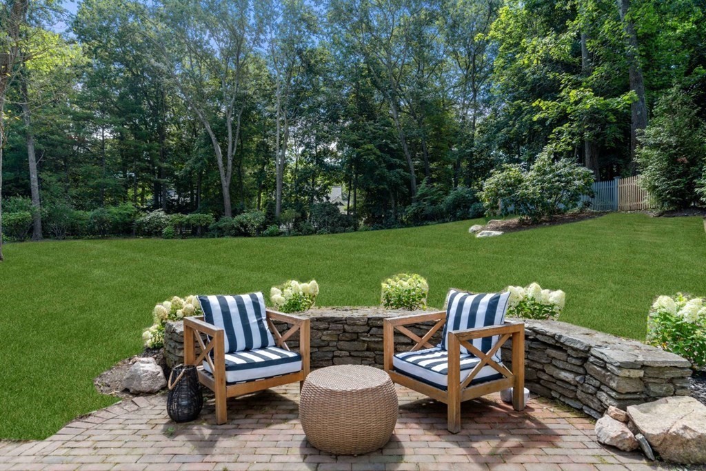 110 Suffolk Road Wellesley, MA 02481 - Photo 25 of 29 a view of a patio with table and chairs potted plants and a palm tree