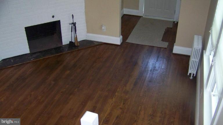 9225 Belair Road Nottingham, MD 21236 - Photo 12 of 21 a living room with wooden floor and a flat screen tv