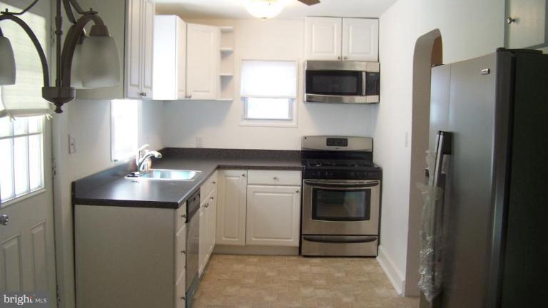 9225 Belair Road Nottingham, MD 21236 - Photo 4 of 21 a kitchen with appliances a sink and cabinets