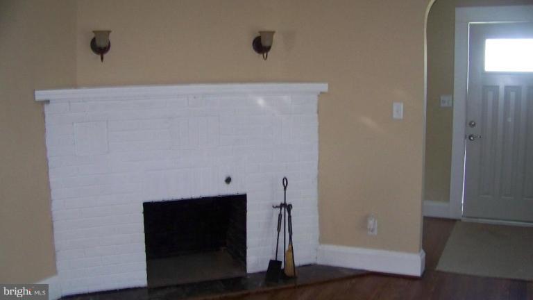 9225 Belair Road Nottingham, MD 21236 - Photo 6 of 21 a view of an empty room with wooden floor and a window