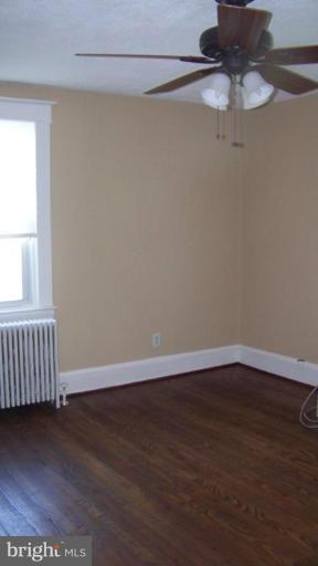 9225 Belair Road Nottingham, MD 21236 - Photo 8 of 21 a view of an empty room with wooden floor and a window