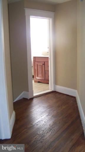 9225 Belair Road Nottingham, MD 21236 - Photo 9 of 21 an empty room with wooden floor and windows