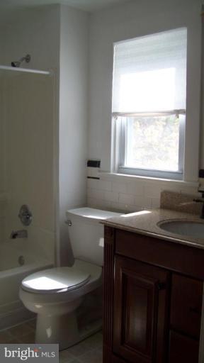 9225 Belair Road Nottingham, MD 21236 - Photo 10 of 21 a bathroom with a toilet a sink and a window