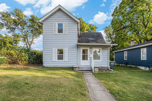 a front view of house with yard and trees
