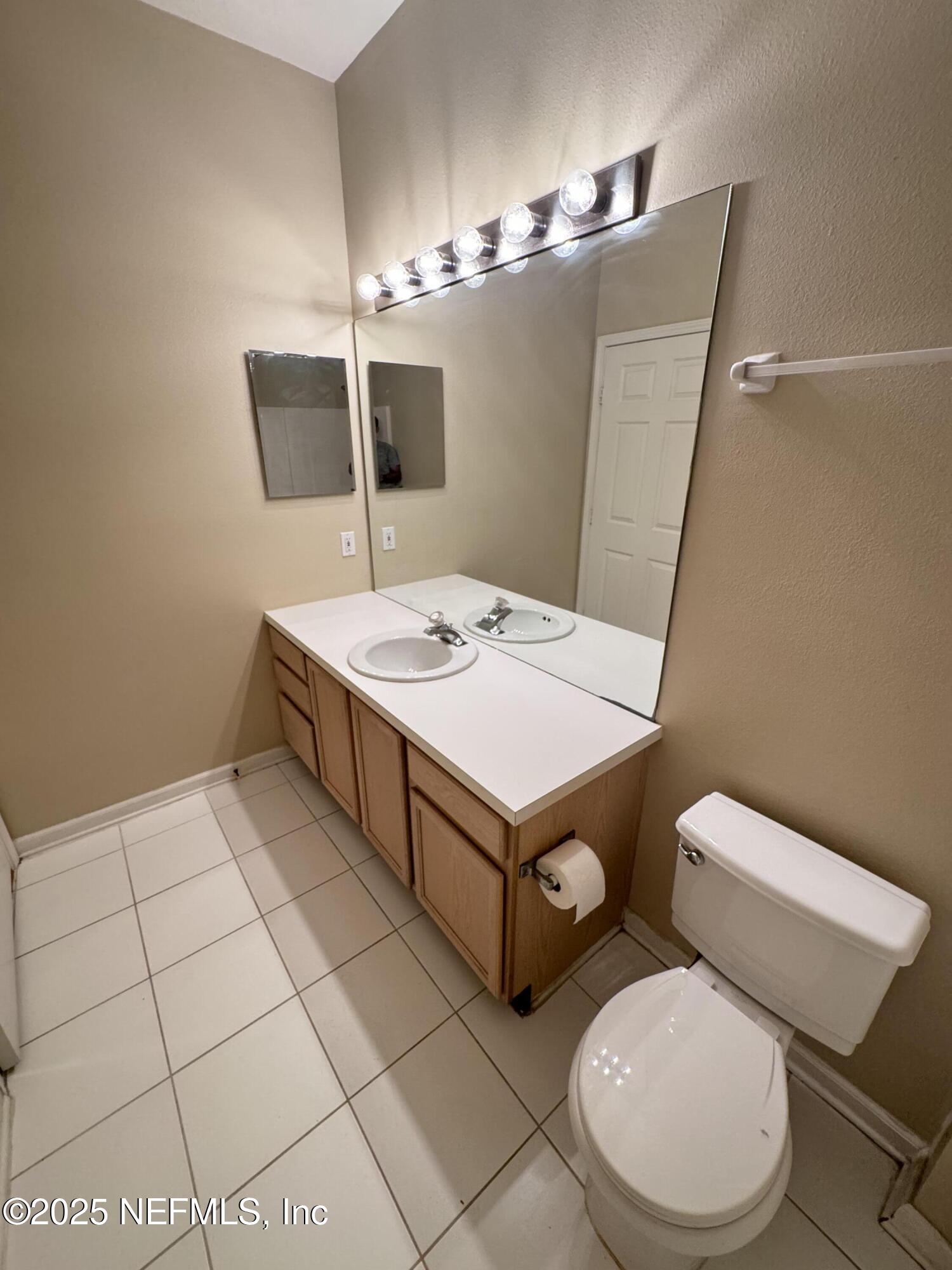 10550 Baymeadows Road, Unit 512 Jacksonville, FL 32256 - Photo 15 of 24 a white toilet sitting next to a bathroom sink