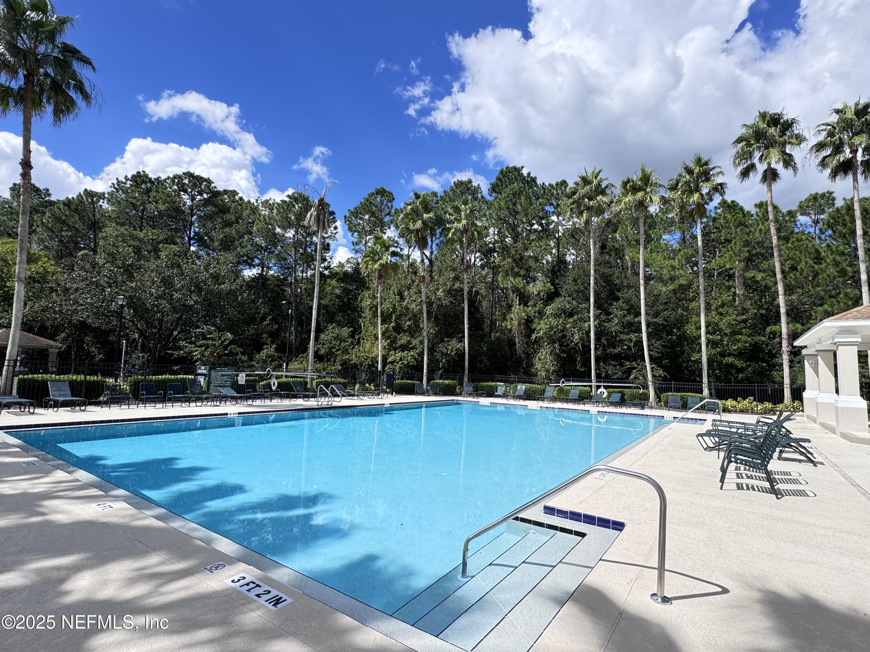 10550 Baymeadows Road, Unit 512 Jacksonville, FL 32256 - Photo 20 of 24 a view of a swimming pool with chairs