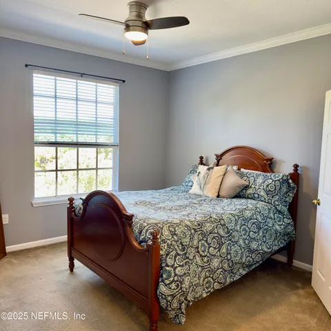 a bedroom with a bed and window
