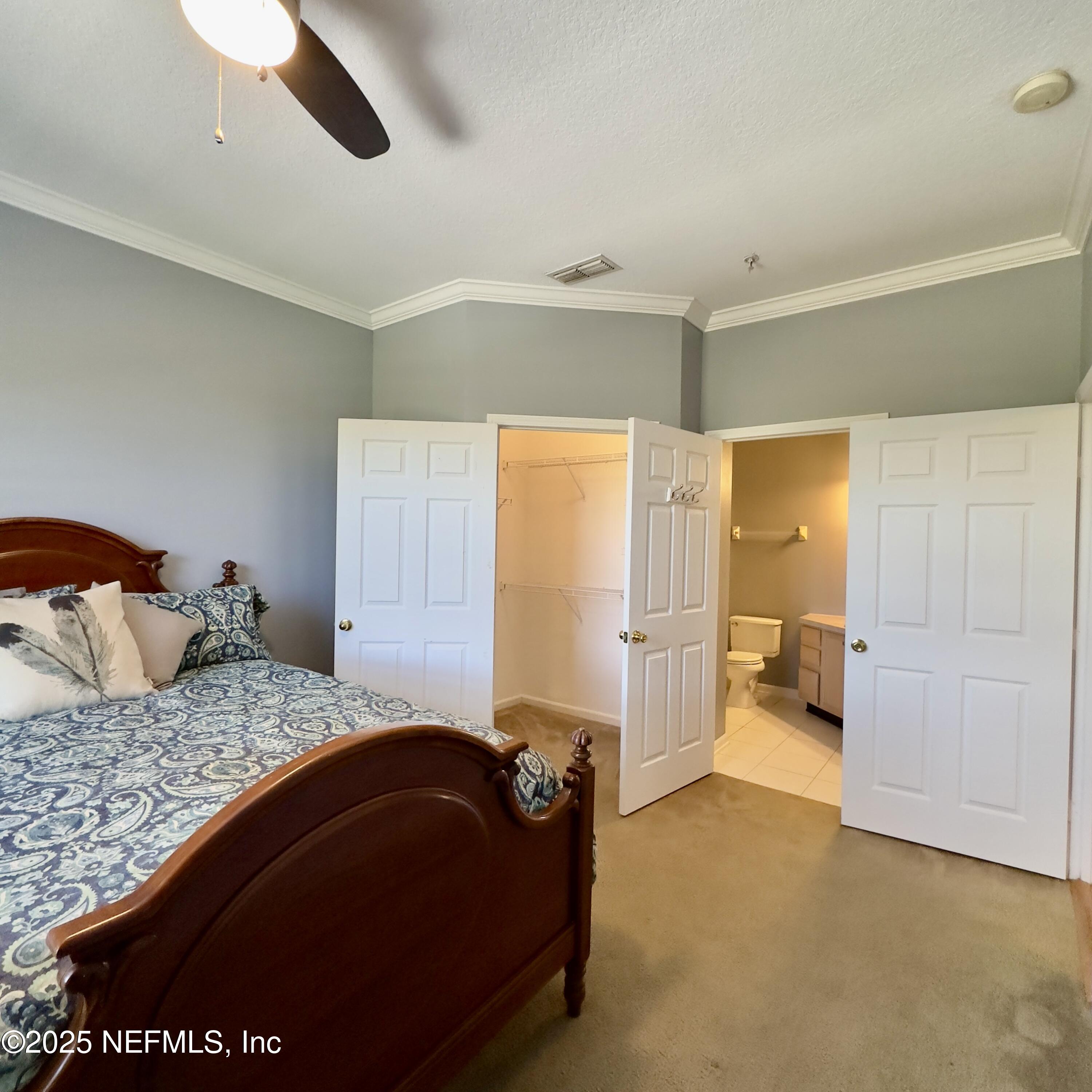 10550 Baymeadows Road, Unit 512 Jacksonville, FL 32256 - Photo 9 of 24 a bedroom with a bed and a walk in closet