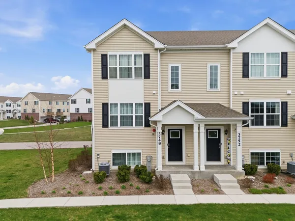 a front view of a house with a yard
