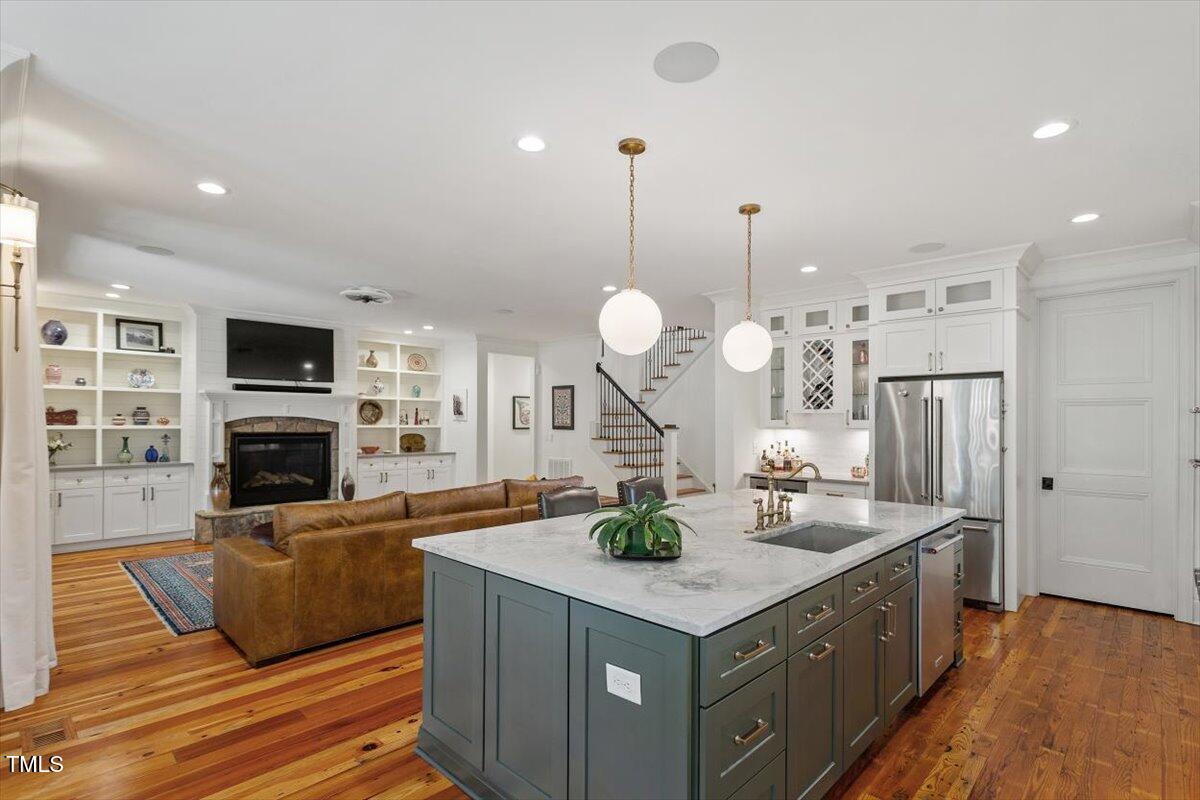 2613 Bedford Avenue Raleigh, NC 27607 - Photo 11 of 44 a large kitchen with stainless steel appliances a large center island attached withe living room