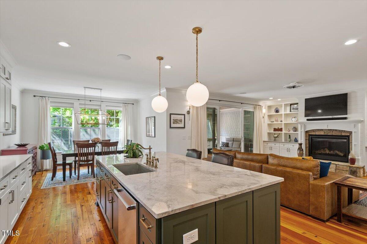 2613 Bedford Avenue Raleigh, NC 27607 - Photo 12 of 44 a view of a kitchen with granite countertop a stove a sink a dining table and chairs