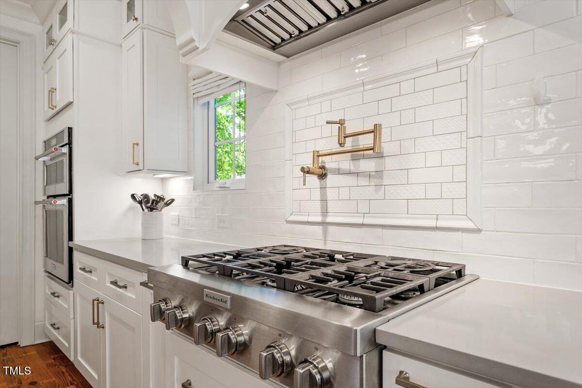 2613 Bedford Avenue Raleigh, NC 27607 - Photo 13 of 44 a stove top oven sitting inside of a kitchen