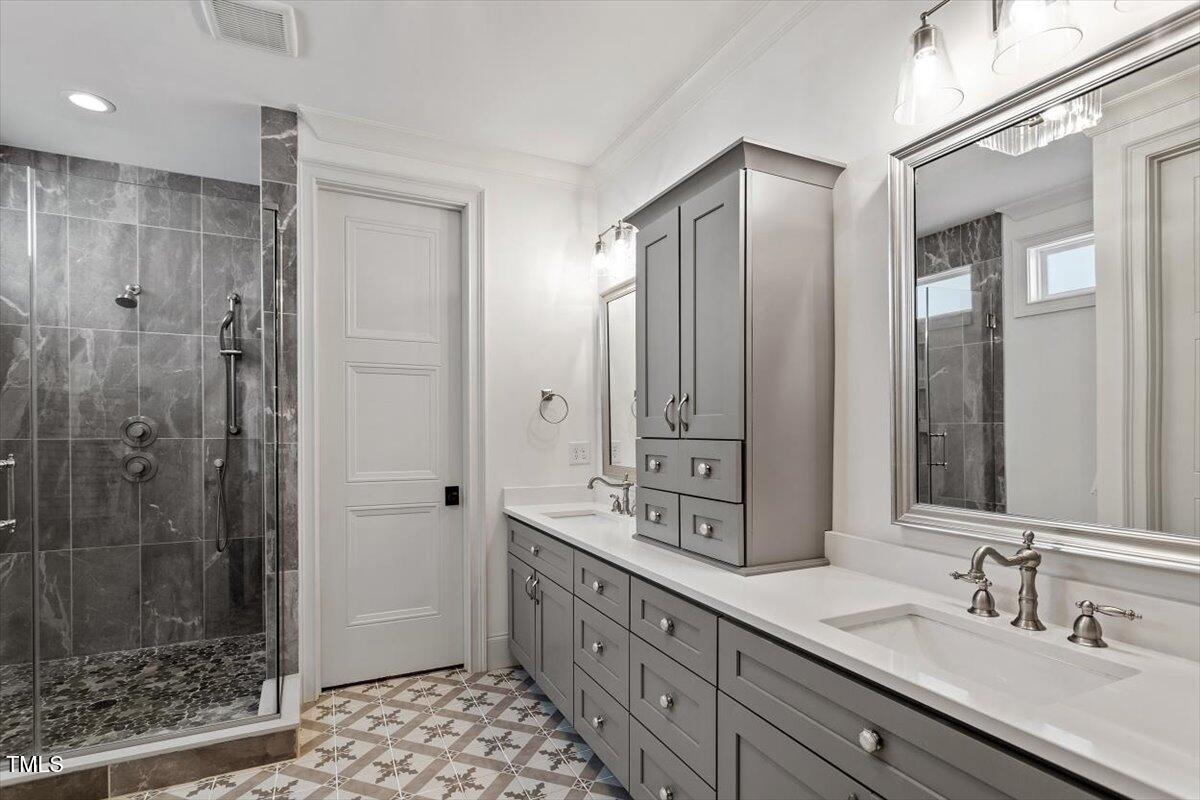 2613 Bedford Avenue Raleigh, NC 27607 - Photo 18 of 44 a bathroom with a double vanity sink mirror and shower