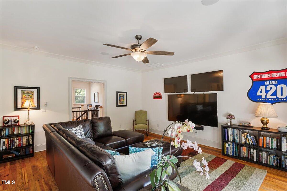2613 Bedford Avenue Raleigh, NC 27607 - Photo 29 of 44 a living room with furniture and a flat screen tv