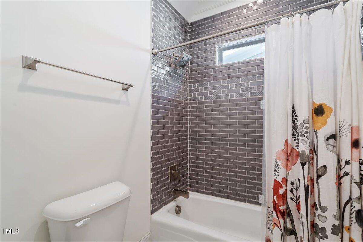 2613 Bedford Avenue Raleigh, NC 27607 - Photo 33 of 44 a bathroom with a shower and a toilet