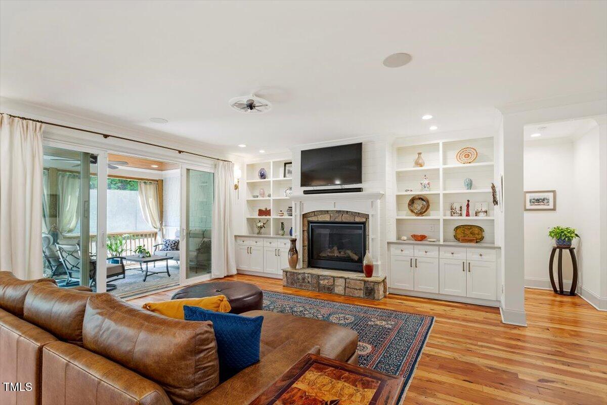 2613 Bedford Avenue Raleigh, NC 27607 - Photo 7 of 44 a living room with furniture a flat screen tv and a fireplace