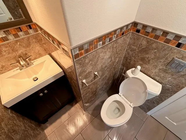 a bathroom with a toilet and a mirror