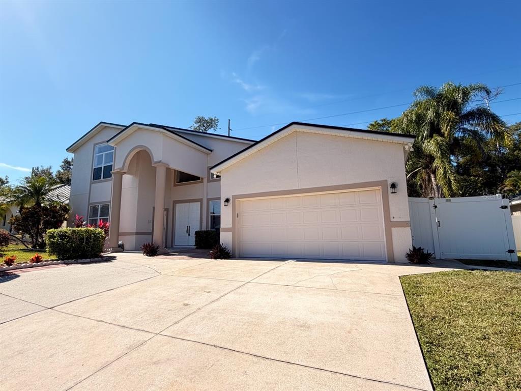 9768 Bay Vista Estates Boulevard Orlando, FL 32836 - Photo 2 of 28 a front view of a house with a yard and garage