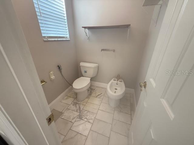 9768 Bay Vista Estates Boulevard Orlando, FL 32836 - Photo 21 of 28 a bathroom with a toilet and a shower