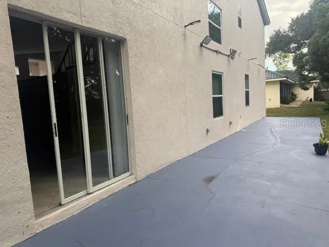 a backyard of a house with lots of green space and fountain