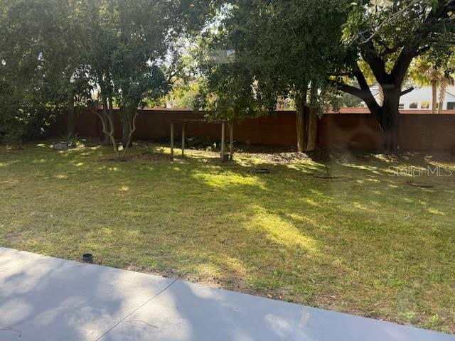 9768 Bay Vista Estates Boulevard Orlando, FL 32836 - Photo 27 of 28 a backyard of a house with lots of green space and fountain