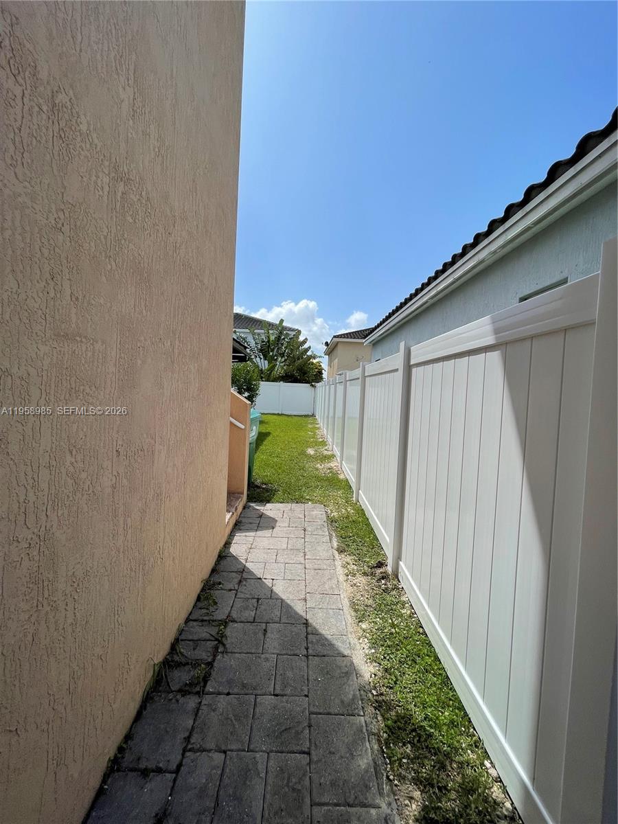 9242 Southwest 171st Court, Unit A Miami, FL 33196 - Photo 6 of 7 a view of a backyard with pathway