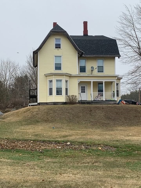 a front view of a house with a yard