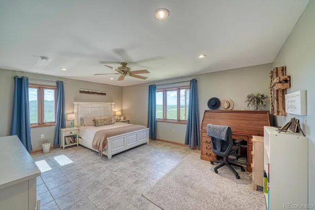 a spacious bedroom with a bed and a couch