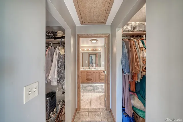 a view of a hallway with wooden floor and entryway