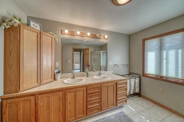 a spacious bathroom with a double vanity sink and mirror