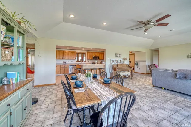 a dining room with furniture and wooden floor