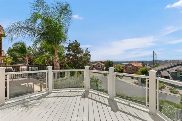 a view of a balcony with wooden floor and outdoor space
