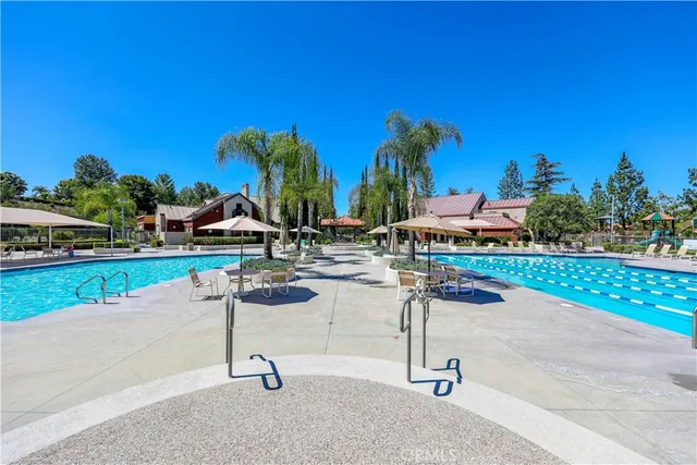 a swimming pool with outdoor seating and yard