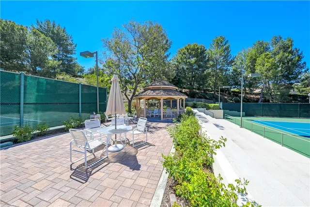 a view of a chair and tables in the backyard
