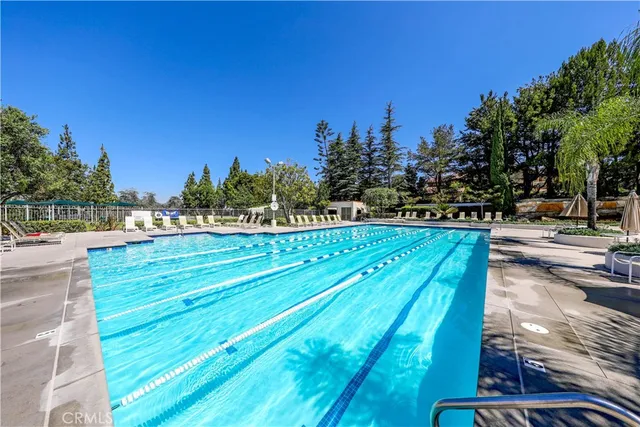 a view of a swimming pool and trees in the background