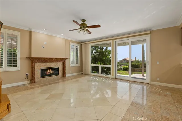 a view of an empty room with a fireplace and a window