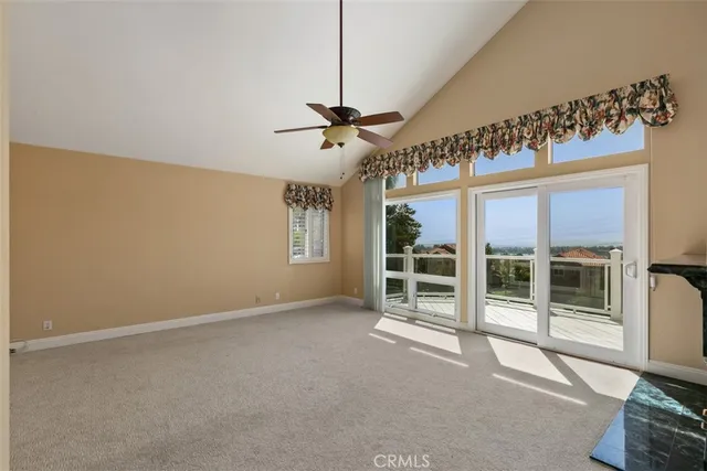 a view of a livingroom with an empty space and a ceiling fan