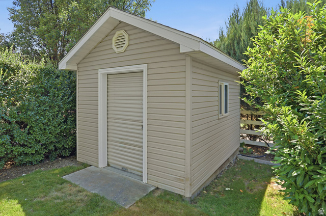 2190 750 West Perry, UT 84302 - Photo 8 of 42 Detached storage shed featuring horizontal siding, a roll-up door, a single window, and a concrete pad