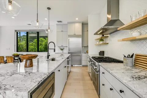 a kitchen with lots of counter space and windows